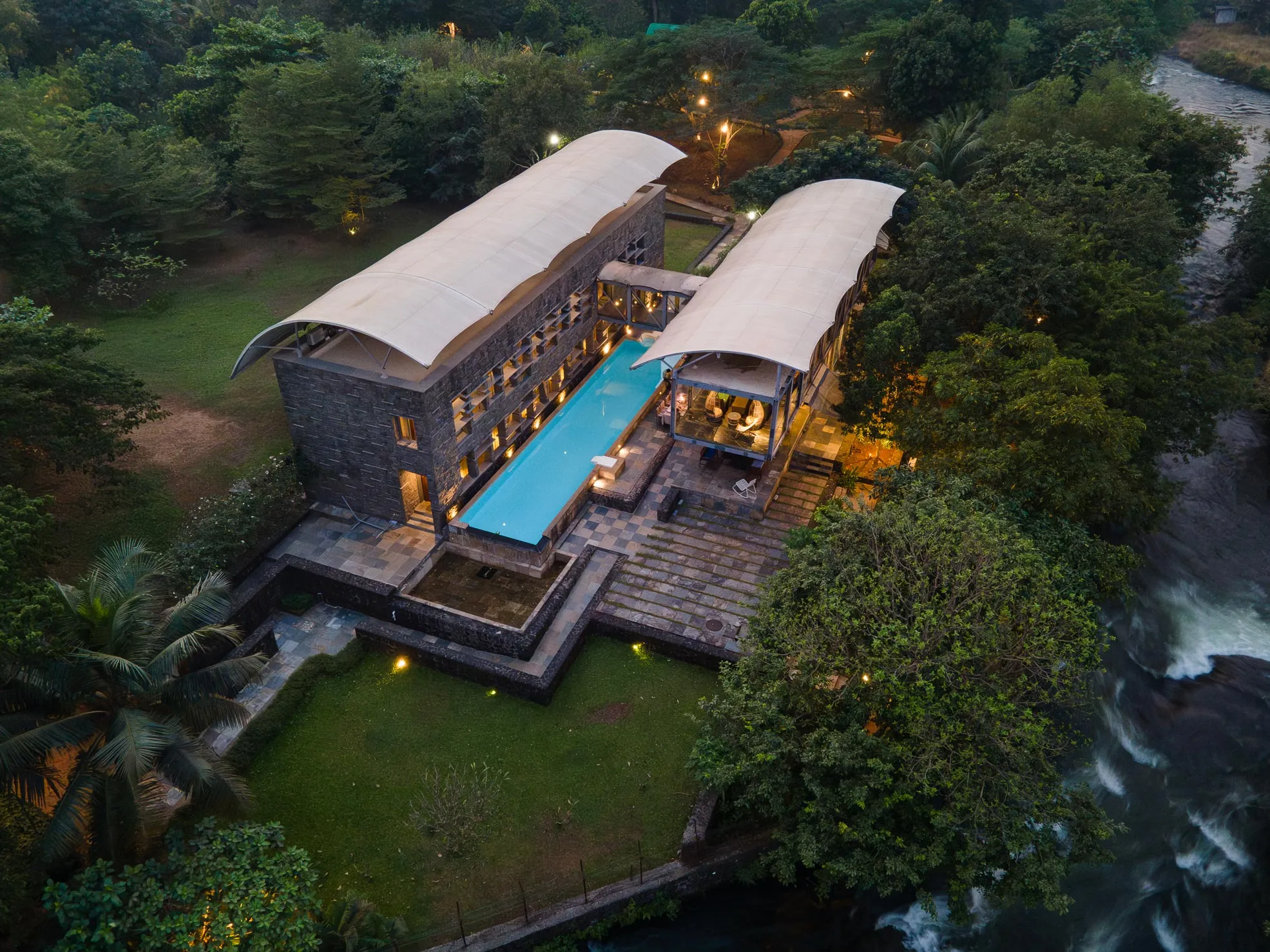 Night view of villa with a pool in Karjat - Maharaja House