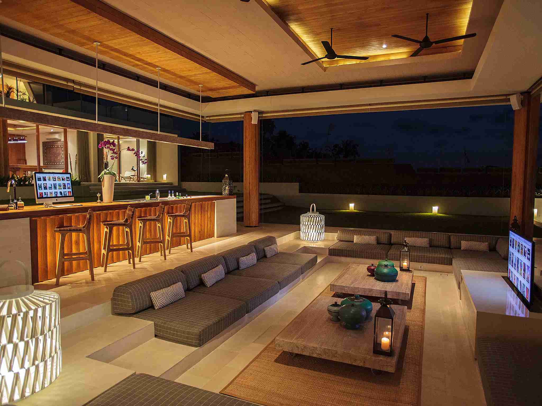 The Iman Villa - Bar and living area at night