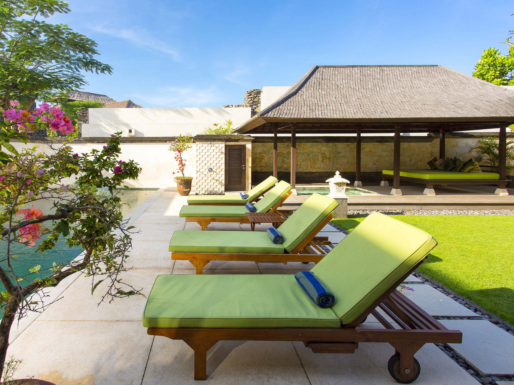 Bayu Gita Residence - Poolside deck chairs